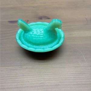 Green hen on nest 2 inches wide 1 inch tall